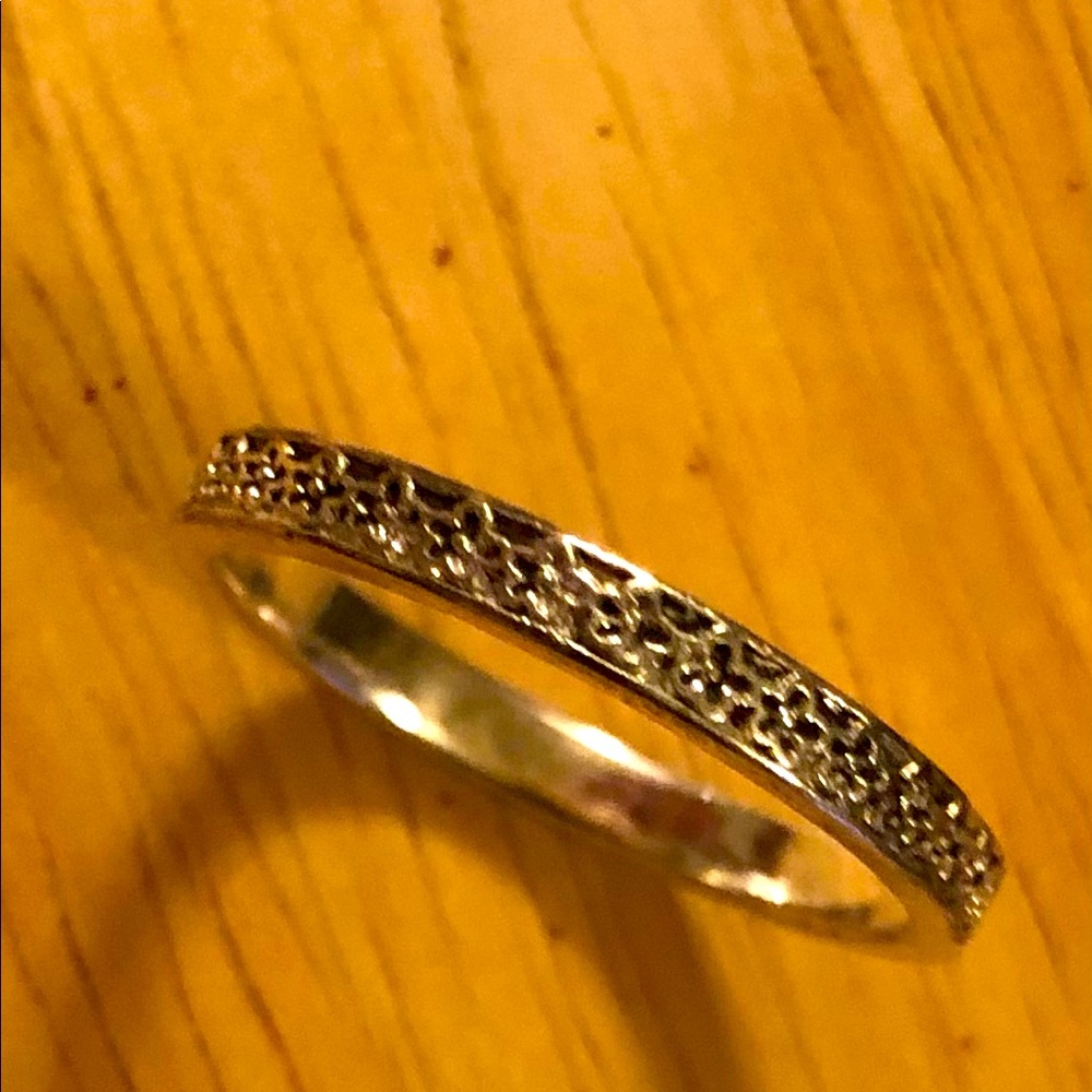 Silver band ring with design.